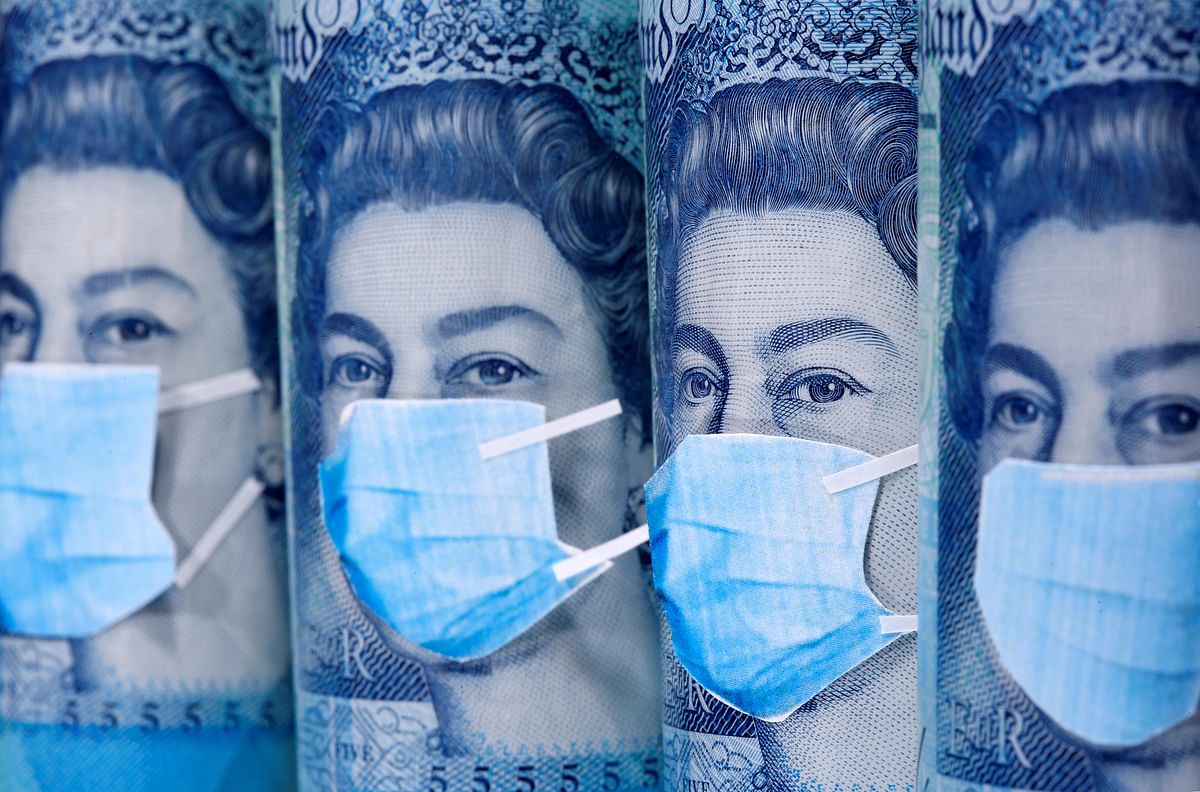 Queen Elizabeth II is seen with printed medical masks on the Pound banknotes in this illustration. (Credit: Reuters Photo)