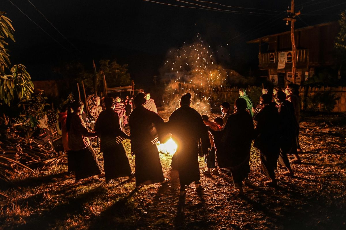 Naga tribeswomen taking part in an overnight ceremony to bless the harvest in Satpalaw Shaung village, Lahe township in Myanmar's Sagaing region. - A haunting refrain pierces the night as the tribeswomen of the Gongwang Bonyo, among the most isolated people in Myanmar, dance around a campfire to bless the harvest ahead. (AFP Photo)