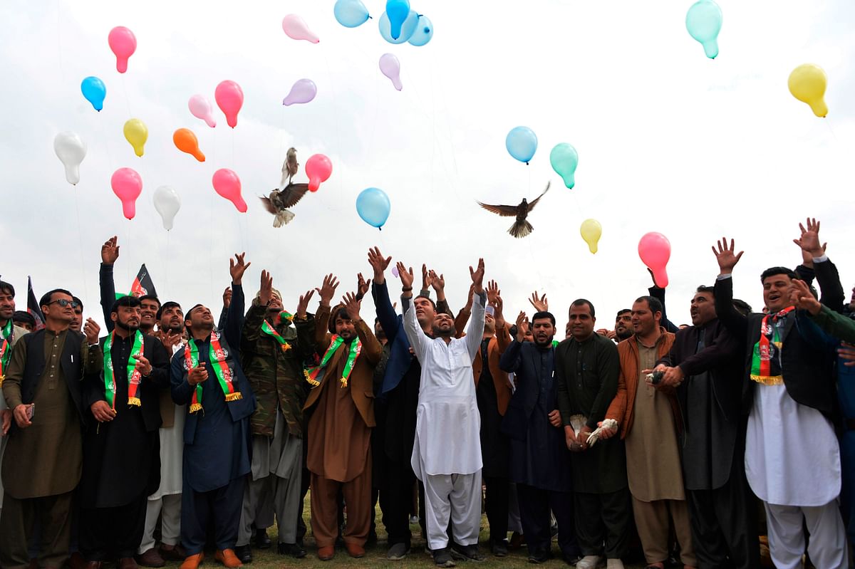 Youth release balloons and pigeons as they celebrate the reduction in violence, in Jalalabad on February 28, 2020. - If the so-called