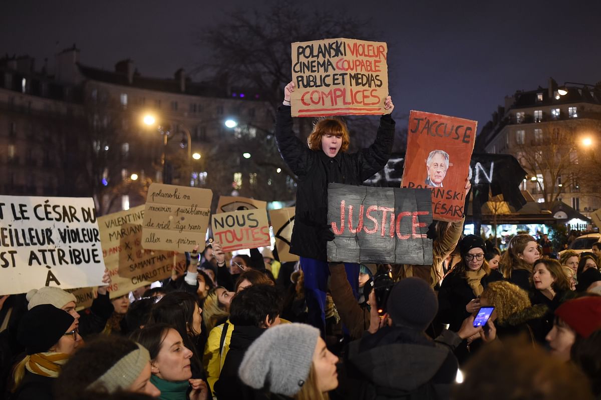 Feminist activists hold signs during a demonstration outside the Salle Pleyel in Paris as guests arrive for the 45th edition of the Cesar Film Awards ceremony. (AFP Photo)