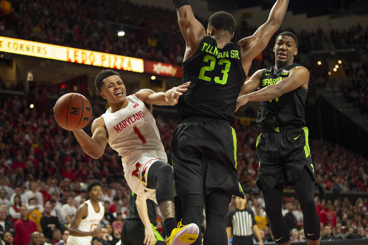 Feb 29, 2020; College Park, Maryland, USA; Maryland Terrapins guard Anthony Cowan Jr. (1) attempts to pass around Michigan State Spartans forward Xavier Tillman Sr. (23) during the second half at XFINITY Center. Mandatory Credit: Tommy Gilligan-USA TODAY Sports