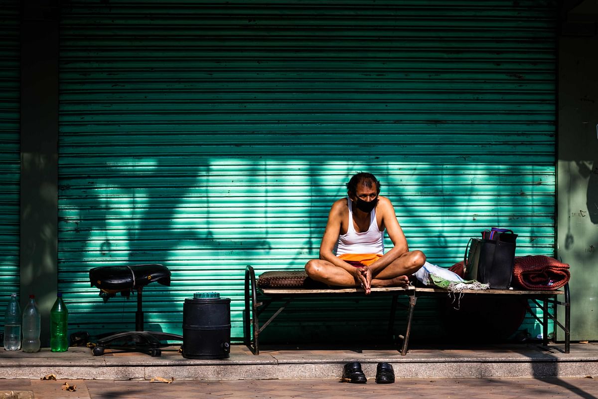 A security guard rests sitting on a cot in front of a closed shop during a government-imposed nationwide lockdown as a preventive measure against the spread of the COVID-19. (AFP Photo)