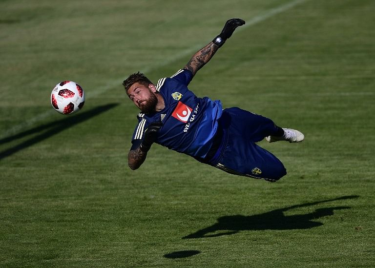 Sweden's goalkeeper Kristoffer Nordfeldt dives during a training session at Spartak stadium in Gelendzhik during the Russia 2018 World Cup football tournament. Credit: PIERRE-PHILIPPE MARCOU / AFP