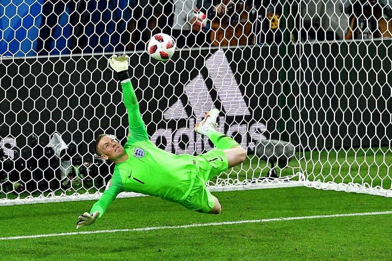 England's goalkeeper Jordan Pickford saves a penalty kicked by Colombia's forward Carlos Bacca during the penalty shootouts during the Russia 2018 World Cup round of 16 football match between Colombia and England at the Spartak Stadium in Moscow on July 3, 2018.  Mladen ANTONOV / AFP