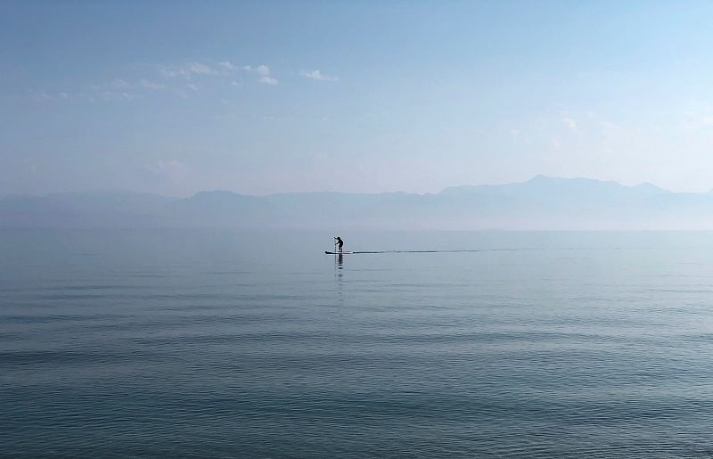 A man paddles in the waters of the Ionian Sea near Sidari settlement on the island of Corfu, Greece. (Reuters Photo)