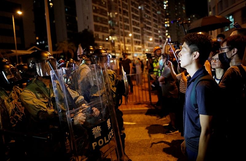 A police officer holds up a shield against protesters at a demonstration at Taikoo station in Hong Kong, China. (Reuters)