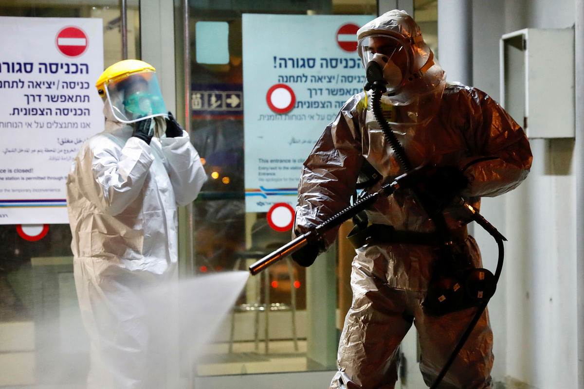 A firefighter sprays disinfectant as a precaution‚ against the coronavirus at the Moshe Dayan Railway Station in Rishon LeTsiyon, Israel. (Credit: AP)