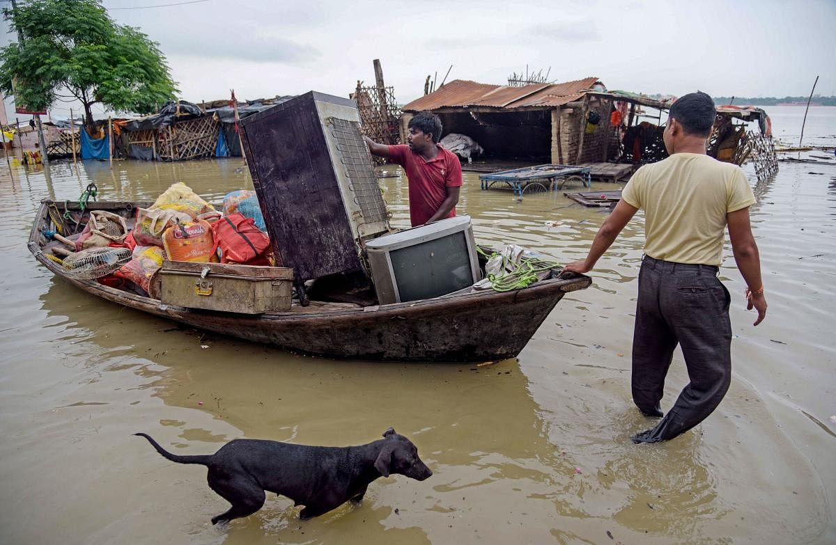 Flood-affected people shift with their belongings from a low lying area on the banks of the River Ganges, in Prayagraj (Allahabad), Monday, August 19, 2019. (PTI Photo)