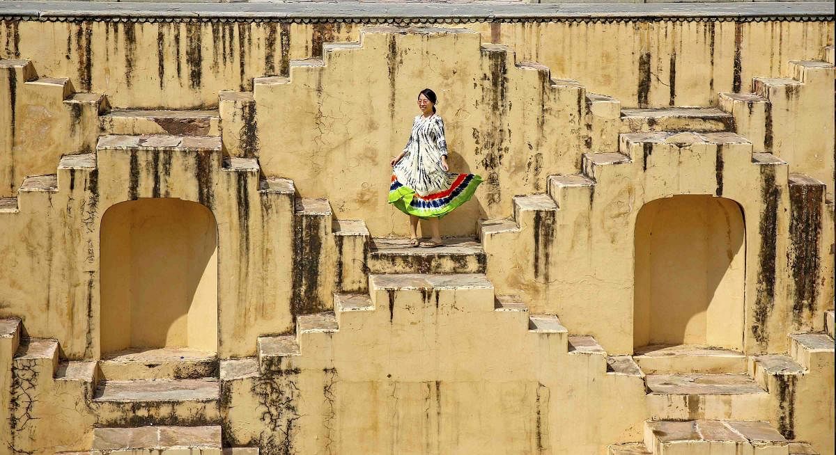 A tourist enjoys at Panna Meena Kund of Amer Fort, in Jaipur on Sunday. (PTI Photo)