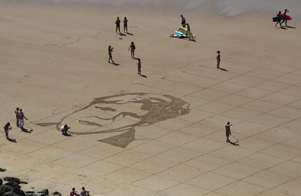 A portrait of German Chancellor Angela Merkel is the first drawing of G-7 leaders drawn into the sand in Biarritz, France Friday, on Aug. 23, 2019. (AP/PTI)