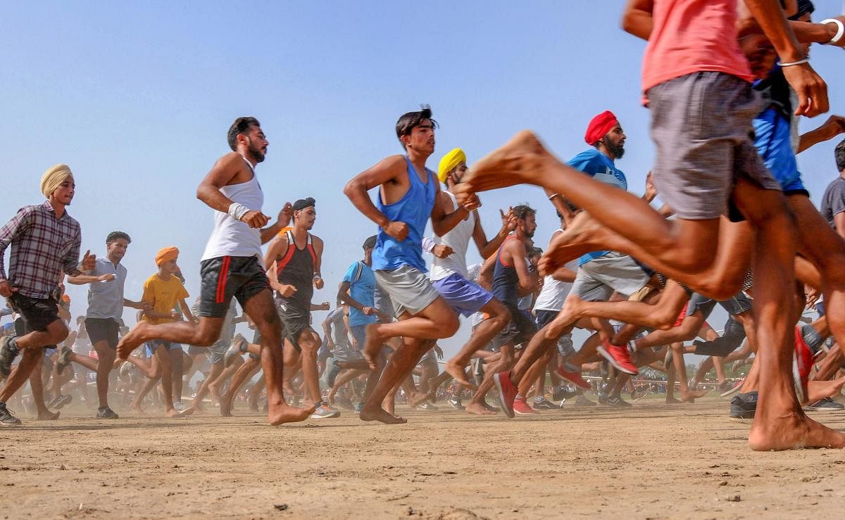 Candidates run during a physical fitness test in an army recruitment rally at Khasa, approximately 15 Kms from Amritsar on Saturday. (AP/PTI Photo)