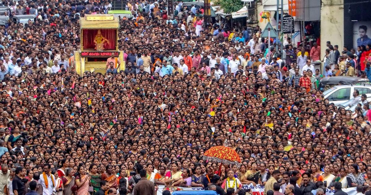 Hundreds of devotees, mostly women, take part in the 'namajapa' (chanting the name of Lord Ayyappa ) during a march in Kottayam. (PTI Photo)