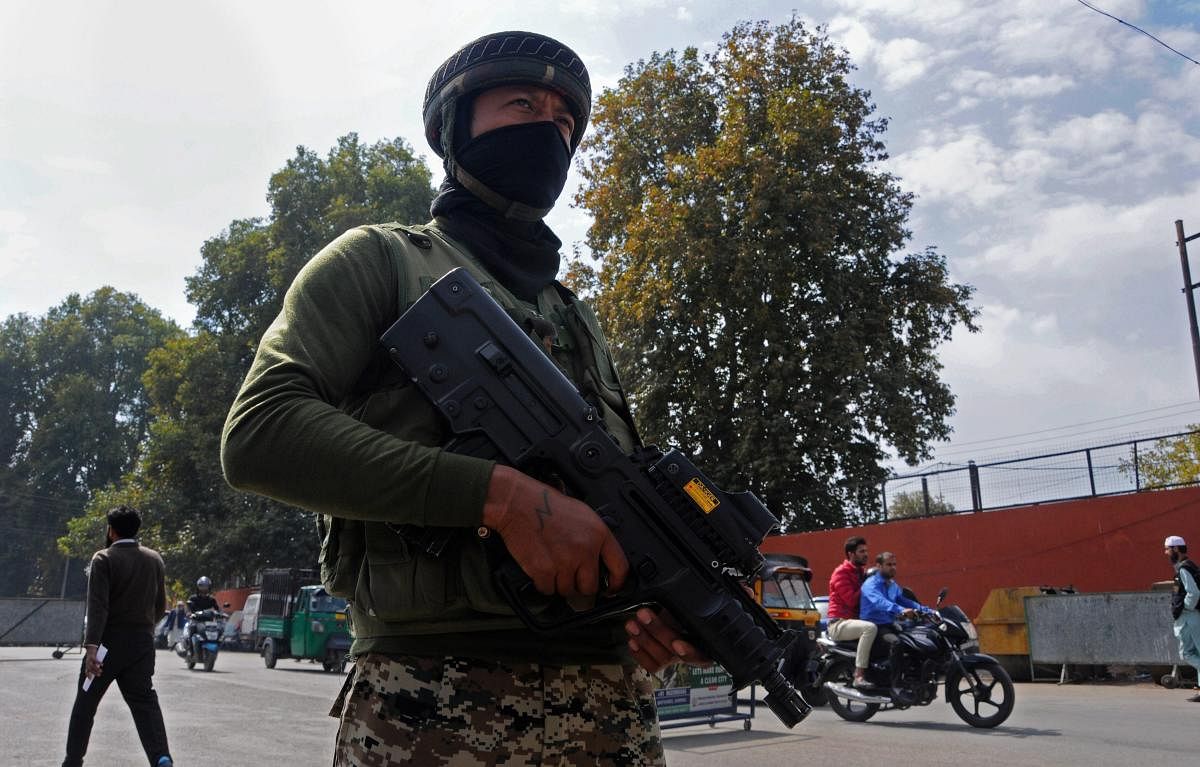 CRPF personnel stand guard ahead of polling for first phase of elections for urban local bodies in Kashmir, in Srinagar on Saturday. (AP/PTI Photo)