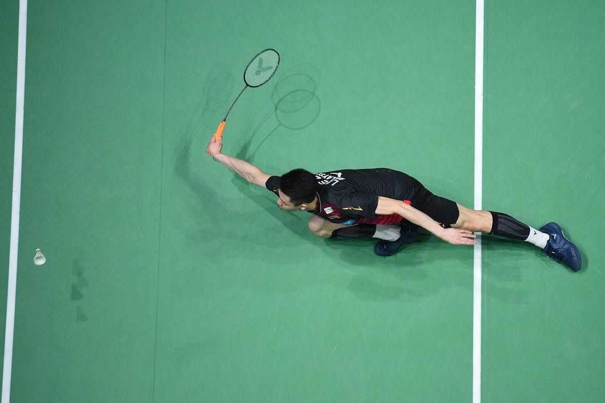 Malaysia's Lee Zii Jia plays a return to Denmark's Viktor Axelson during their All England Open Badminton Championships mens singles semi-final match in Birmingham, central England, on March 14, 2020. (Photo by Oli SCARFF / AFP)
