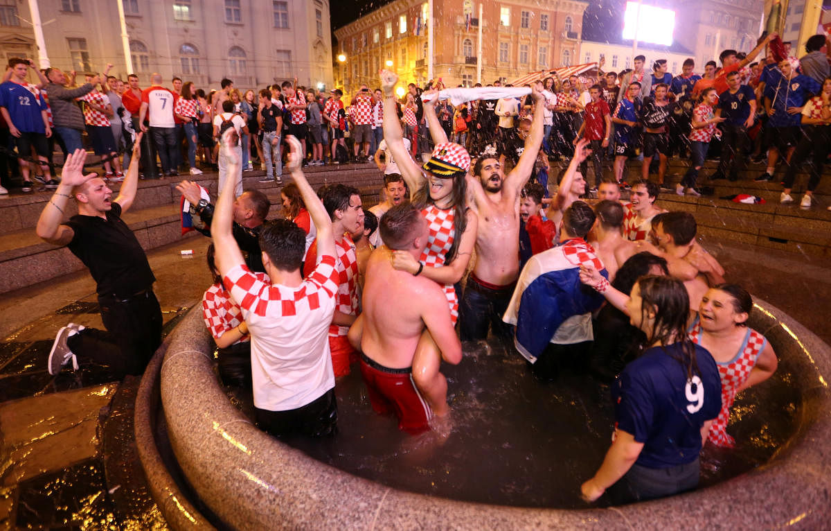 Croatian fans celebrate in the fan zone after Croatia beat England in the World Cup semi-final. (Reuters Photo)