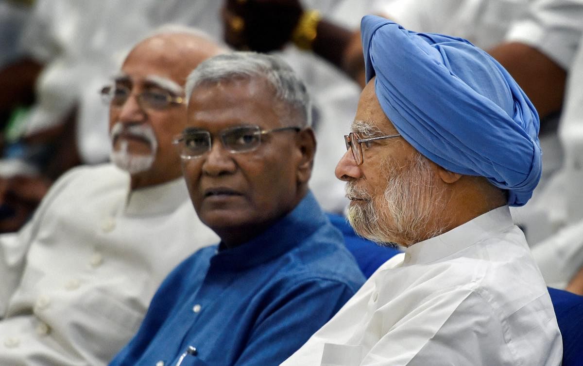 Former prime minister Manmohan Singh, former vice president Hamid Ansari and CPI leader D Raja during the book launch of 'Jawaharlal Nehru' an illustrated biography by A Gopanna, in New Delhi, on Sunday.  PTI Photo
