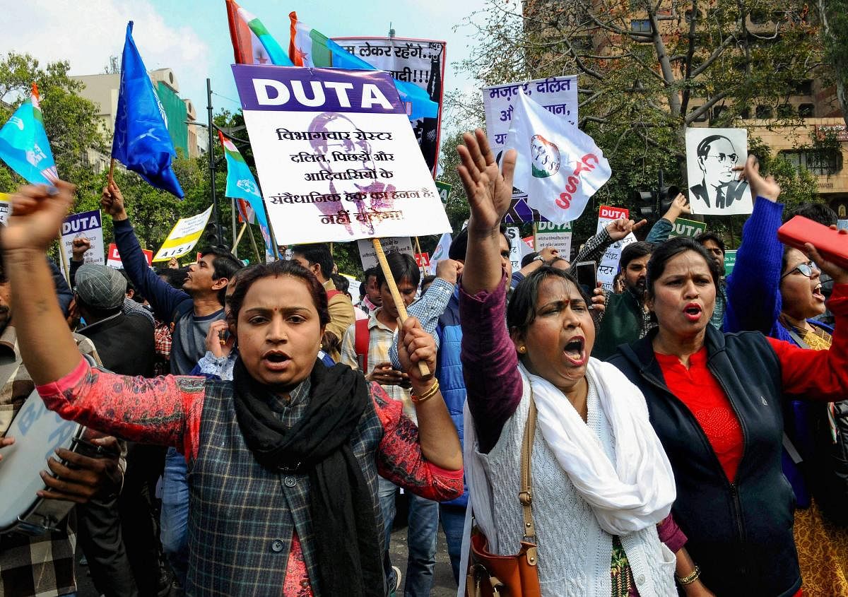 Members of the Delhi University Teacher's Association (DUTA) along with students from several Universities stage a protest against the '13-point roster system' at Jantar Mantar. PTI