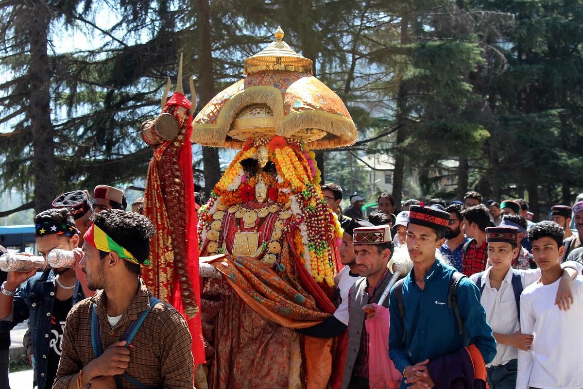 Devotees carry palanquin of a deity during a procession on the first day of a week-long Dussehra celebrations, in Kullu, Tuesday, Oct. 8, 2019. (PTI Photo)