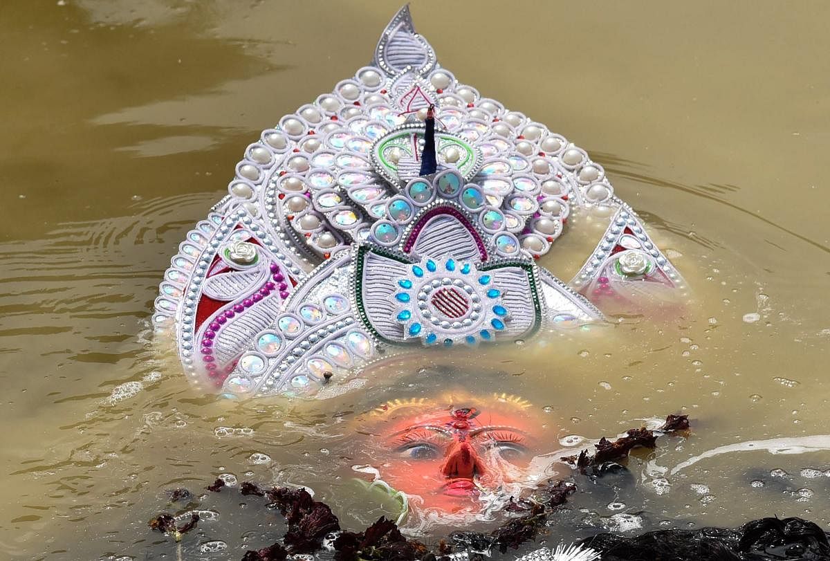 Devotees immerse Goddess Durga idol in a pond on the occasion of Vijayadashami festival, in Patna, Tuesday, Oct. 8, 2019. (PTI Photo)