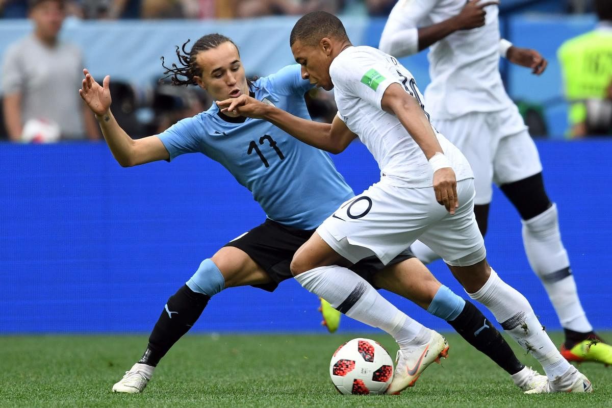 Uruguay's defender Diego Laxalt (L) vies with France's forward Kylian Mbappe during the Russia 2018 World Cup quarter-final football match between Uruguay and France at the Nizhny Novgorod Stadium in Nizhny Novgorod. Reuters  photo
