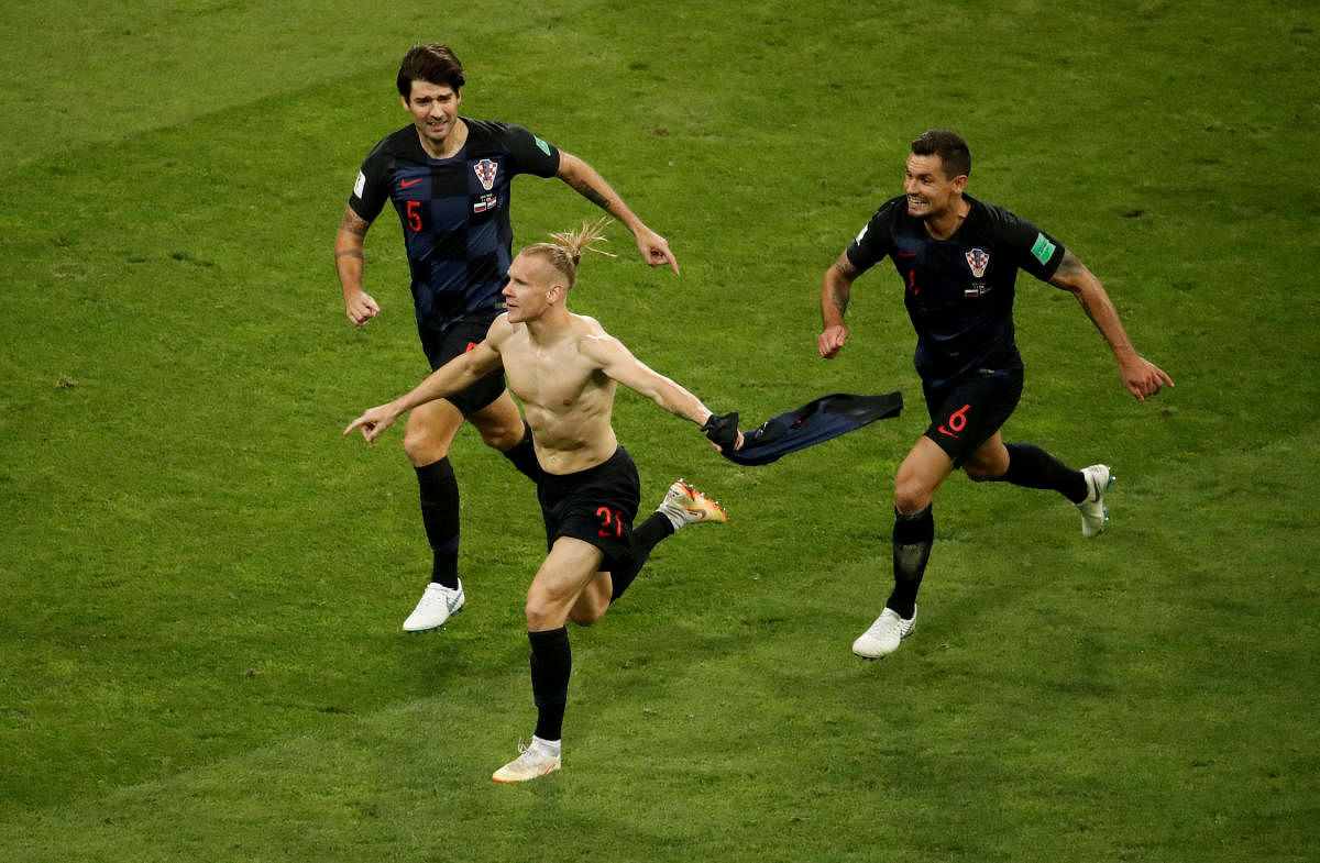 Croatia's Domagoj Vida celebrates their second goal with Vedran Corluka and Dejan Lovren .REUTERS