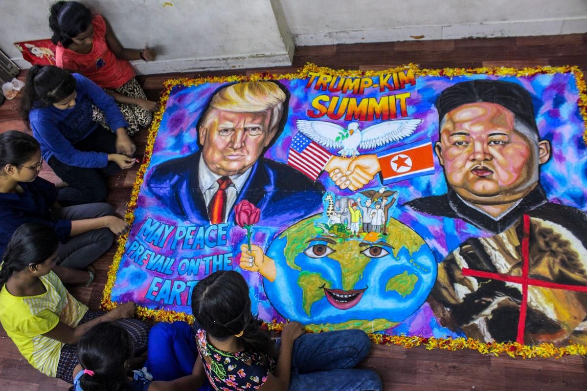 Student make a painting of the US President Donald Trump and North Korean leader Kim Jong-Un ahead of their meet at Singapore Summit, in Mumbai on Monday. PTI Photo