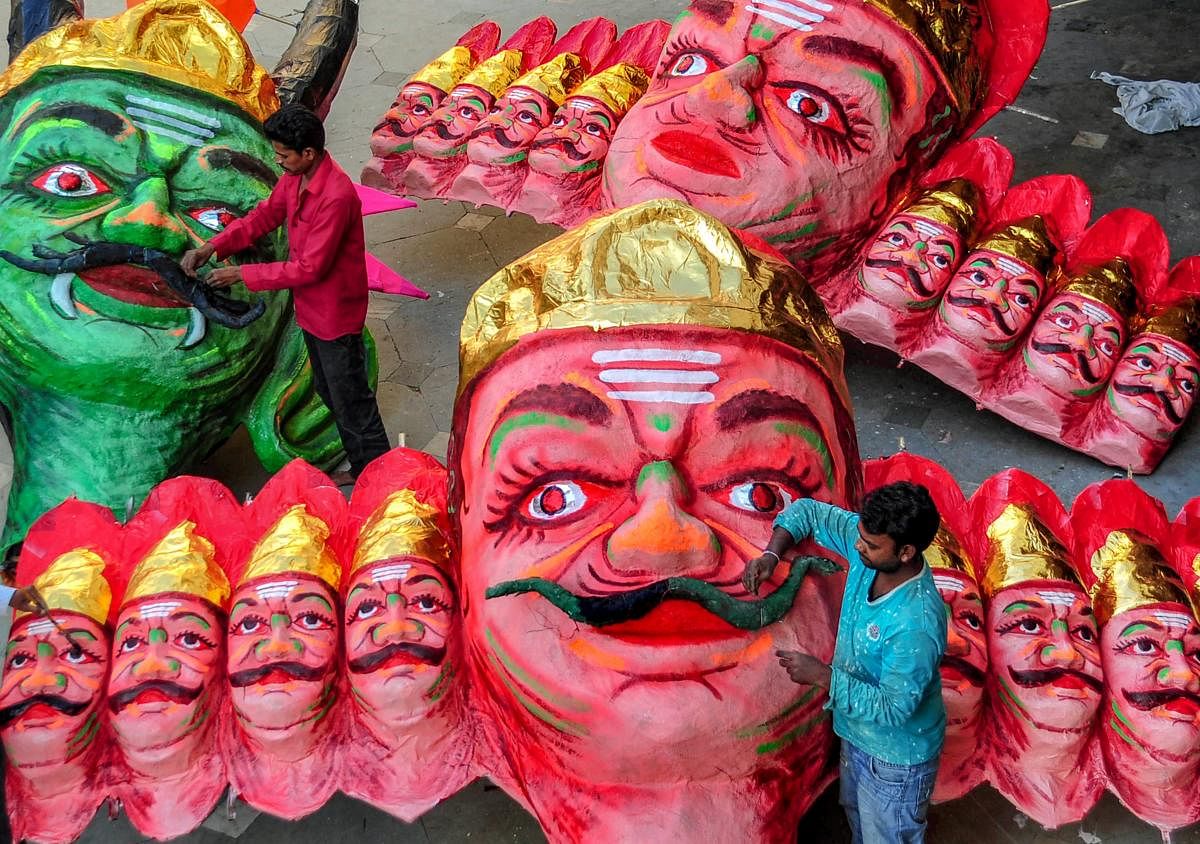 A man works on effigies of the demon-king Ravana at a workshop, ahead of Dussehra festival in Nagpur. (PTI photo)