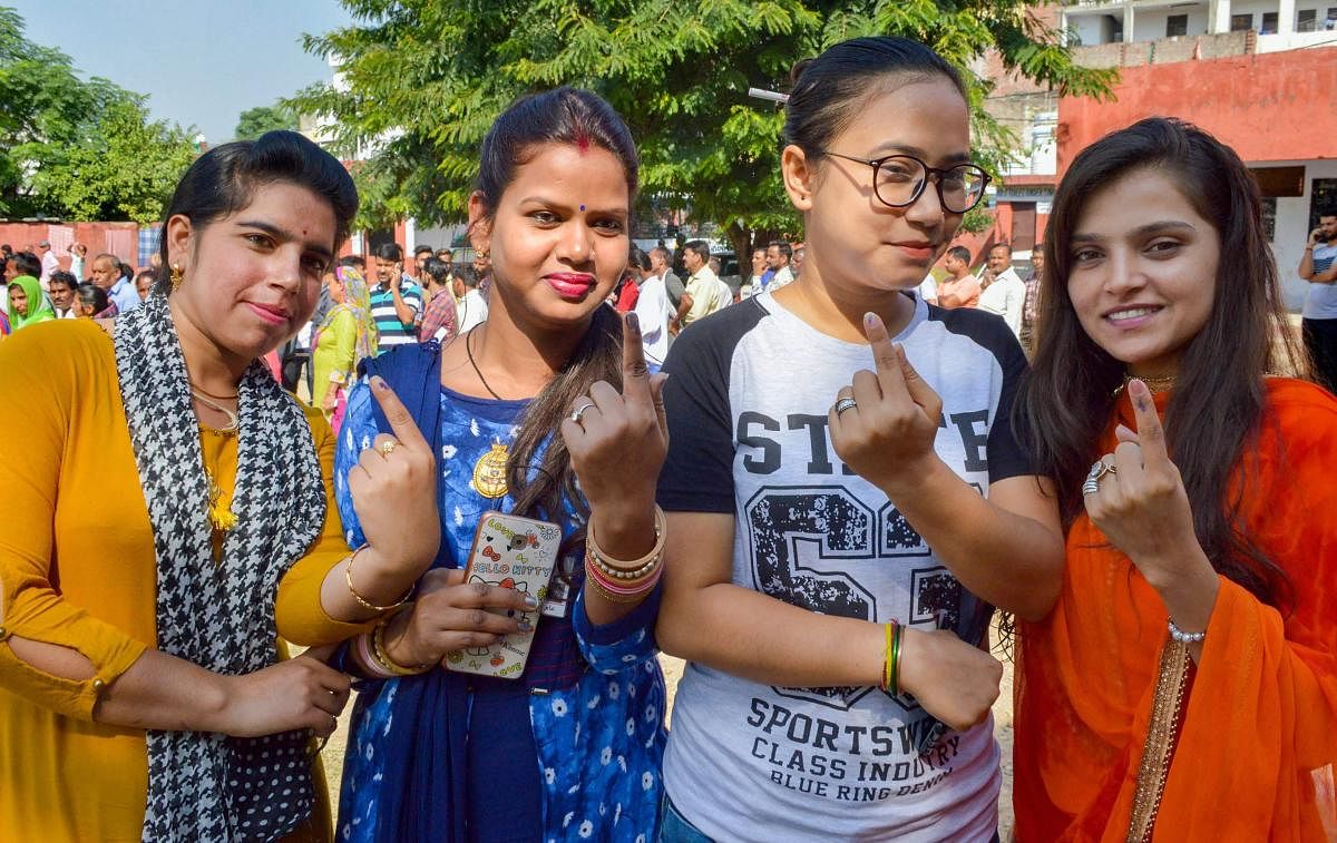 Voters show their inked fingers after casting votes at a polling station during municipal elections in Jammu. (PTI photo)