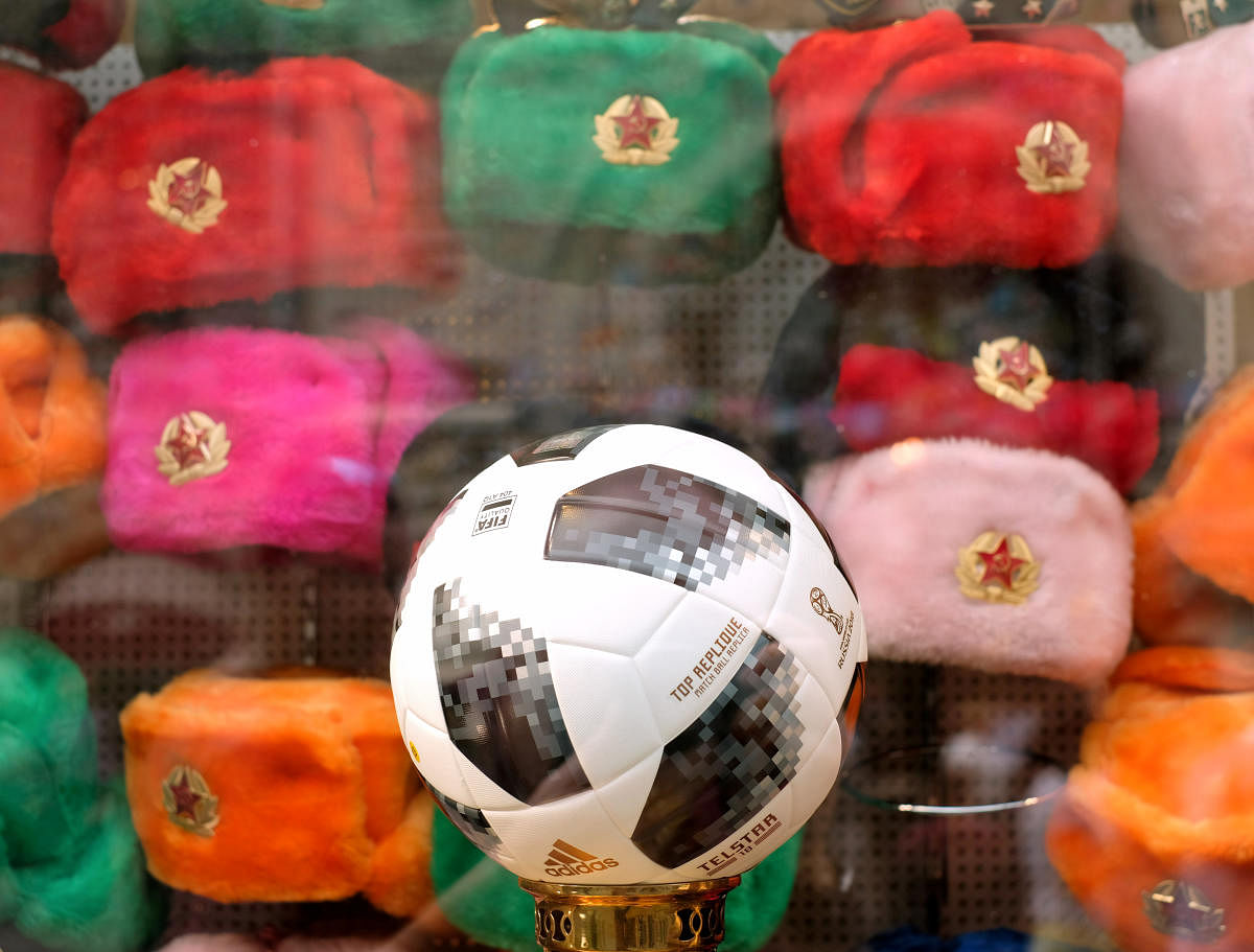 A replica of the FIFA World Cup ball is displayed in front of Russian style hats in a shop window in central Moscow, Russia. (Reuters Photo)