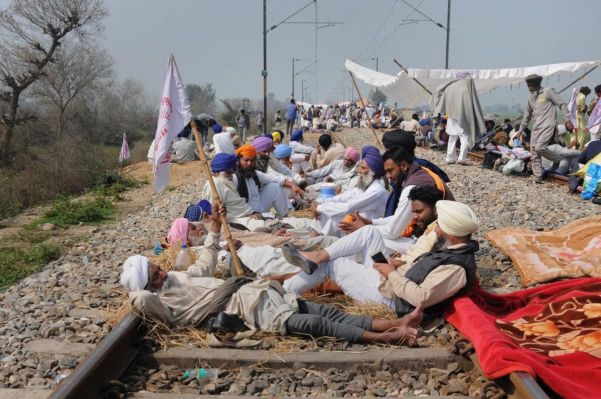 Farmers block a railway tracks during a protest organized under the banner of Kisan Mazdoor Sangharsh Committee (KMSC) against the alleged anti-farmer policies of the state government, at village Devi Dass Pura, 20 km from Amritsar. PTI