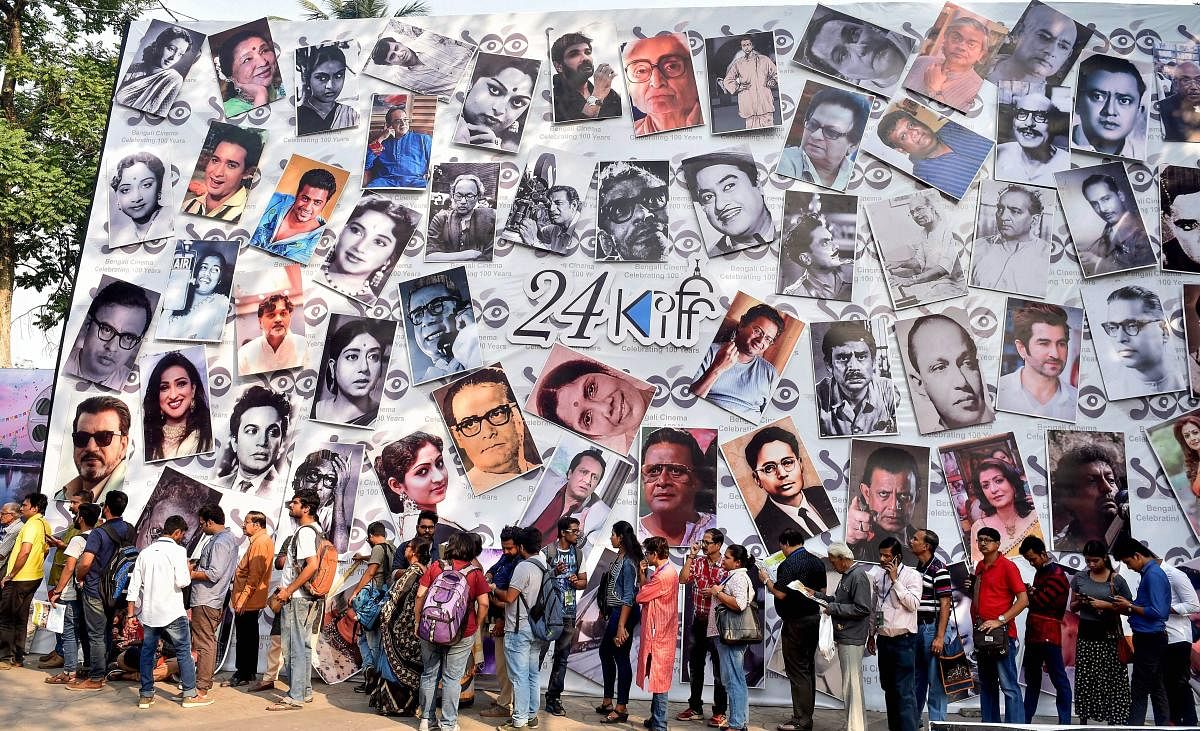 Film lovers stand in a queue to watch the movie during the concluding day of 24th Kolkata International Film Festival in Kolkata.  PTI photo