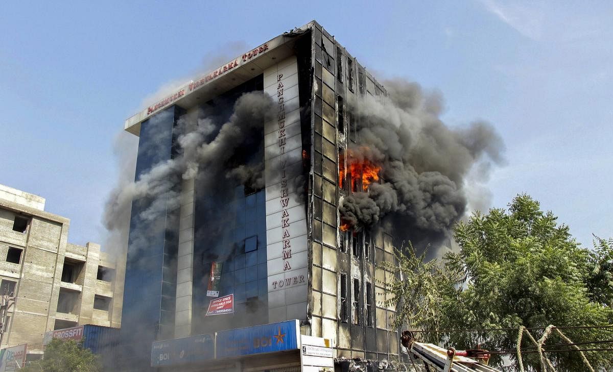 Smoke billows out after a fire broke out in a multi-storey building in Jodhpur. (PTI photo)