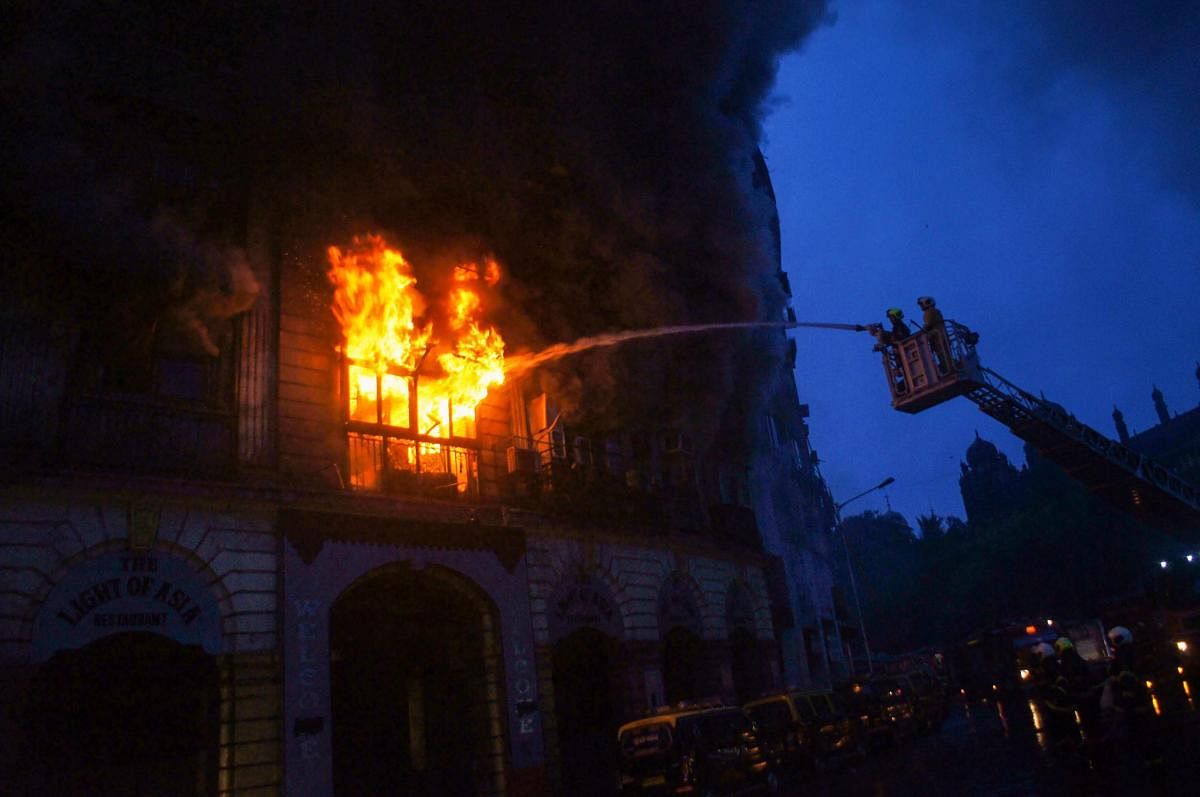 Firefighters douse a fire which broke out at Kothari mansion in south Mumbai on Saturday. PTI Photo