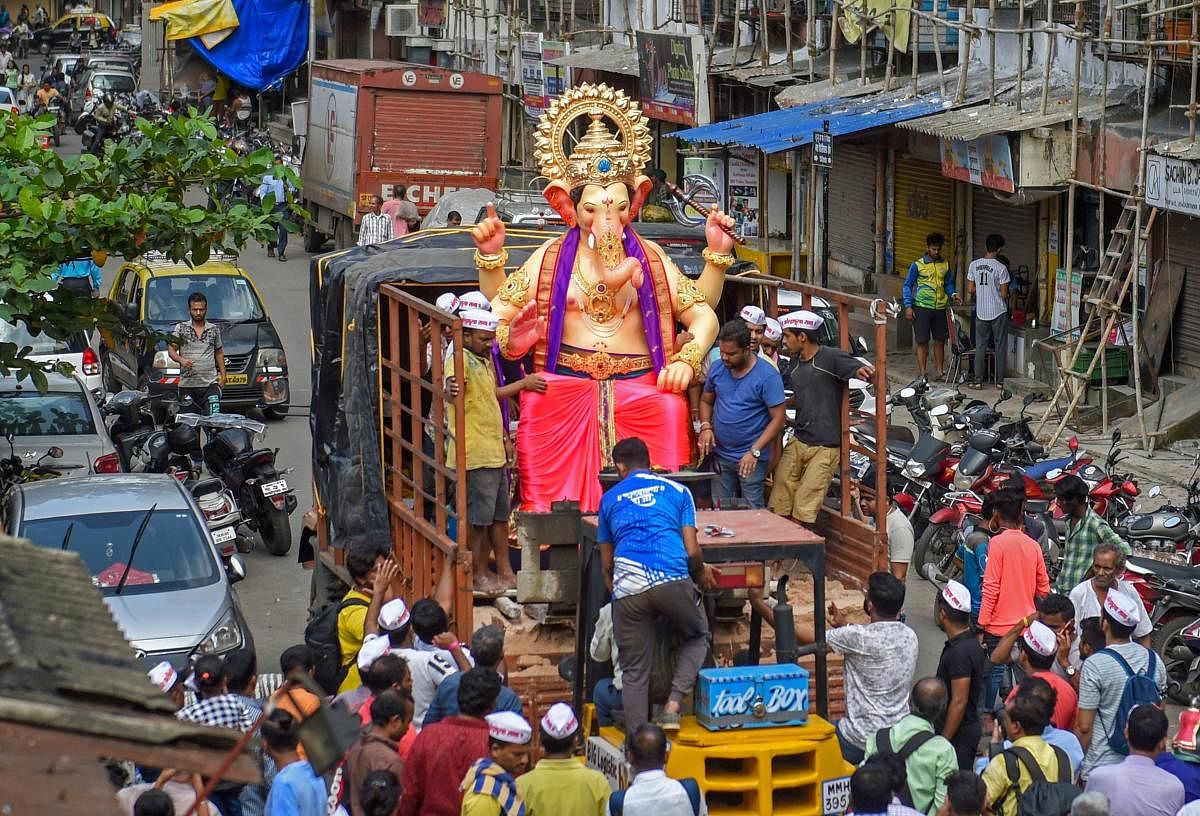 People transport lord Ganesh idol to a Marquee, ahead of Ganesh Chaturthi festival, in Mumbai on Sunday. PTI photo