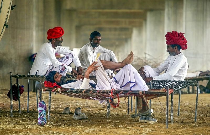 Rajasthani Rebari nomads rest under a flyover, in Greater Noida. (PTI Photo)