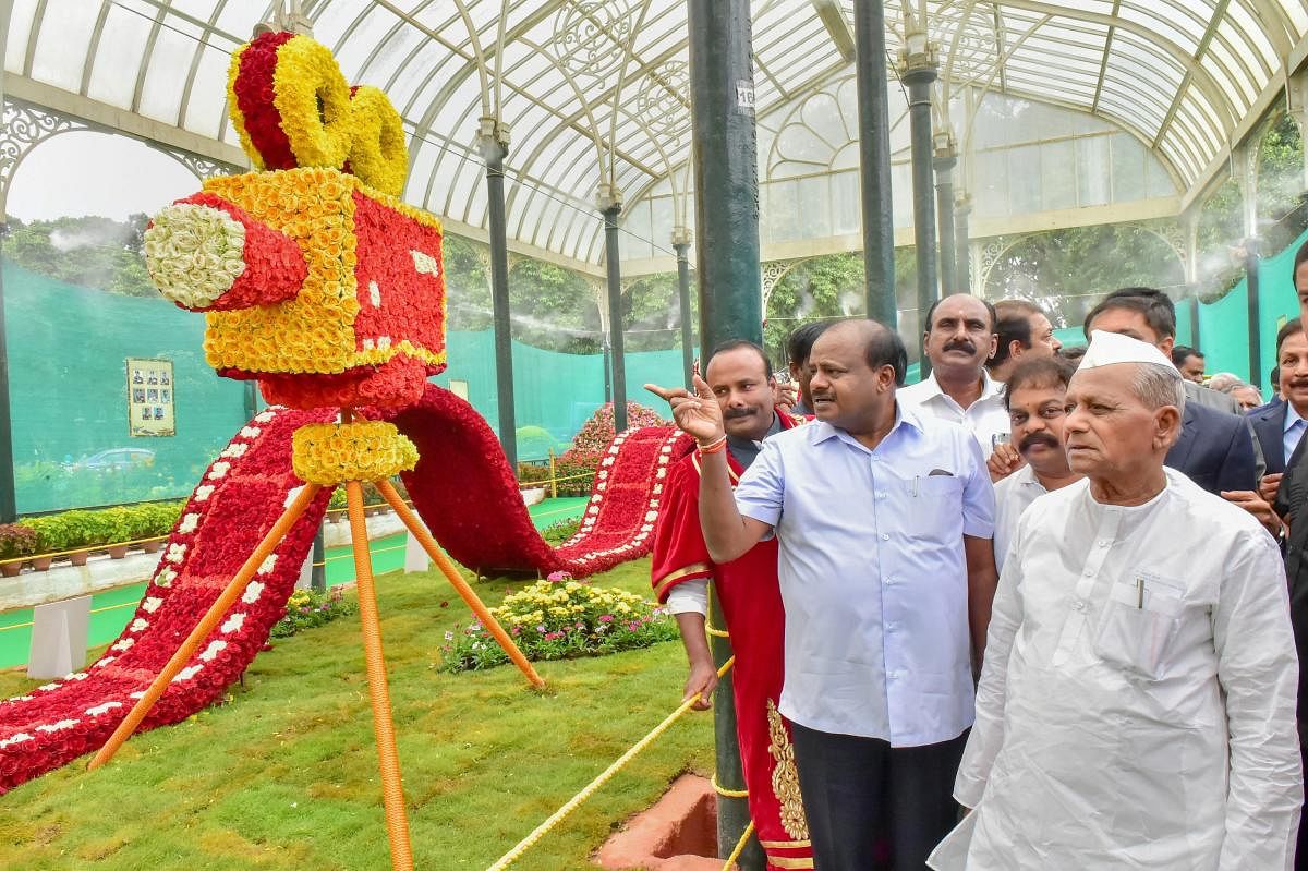 Karnataka Chief Minister HD Kumaraswamy looks at various installations after inaugurating the Lalbagh Flower show organized by the Horticulture Department, in Bengaluru. PTI photo