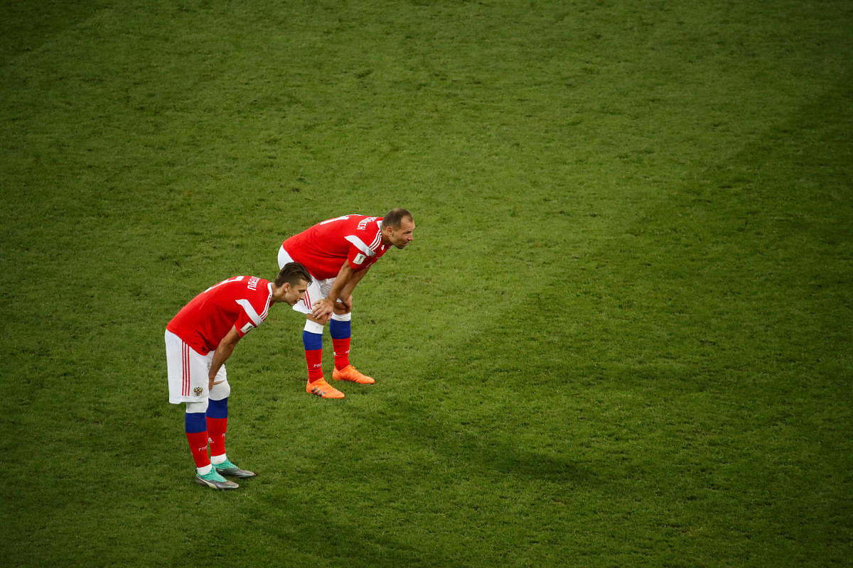 Russia's Ilya Kutepov and Sergei Ignashevich during the break before extra time. REUTERS