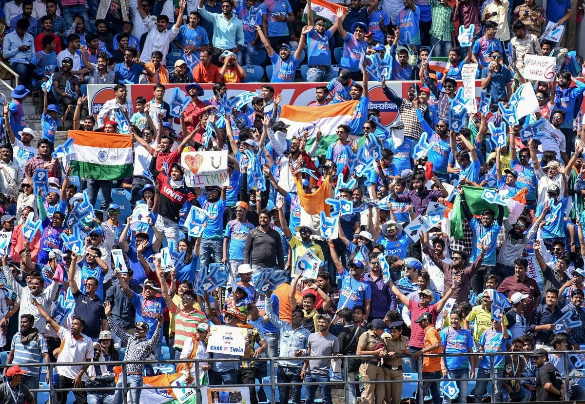 Fans cheer the Indian team during the 2nd ODI cricket match against Australia at Vidarbha Cricket Association Stadium in Nagpur. PTI