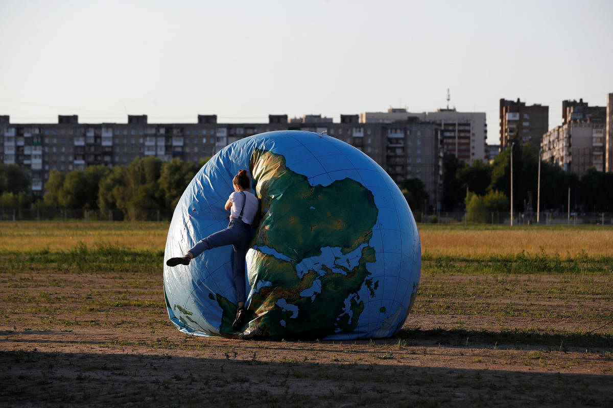A woman jumps on an inflatable globe outside the stadium in Kaliningrad, Russia. (Reuters Photo)