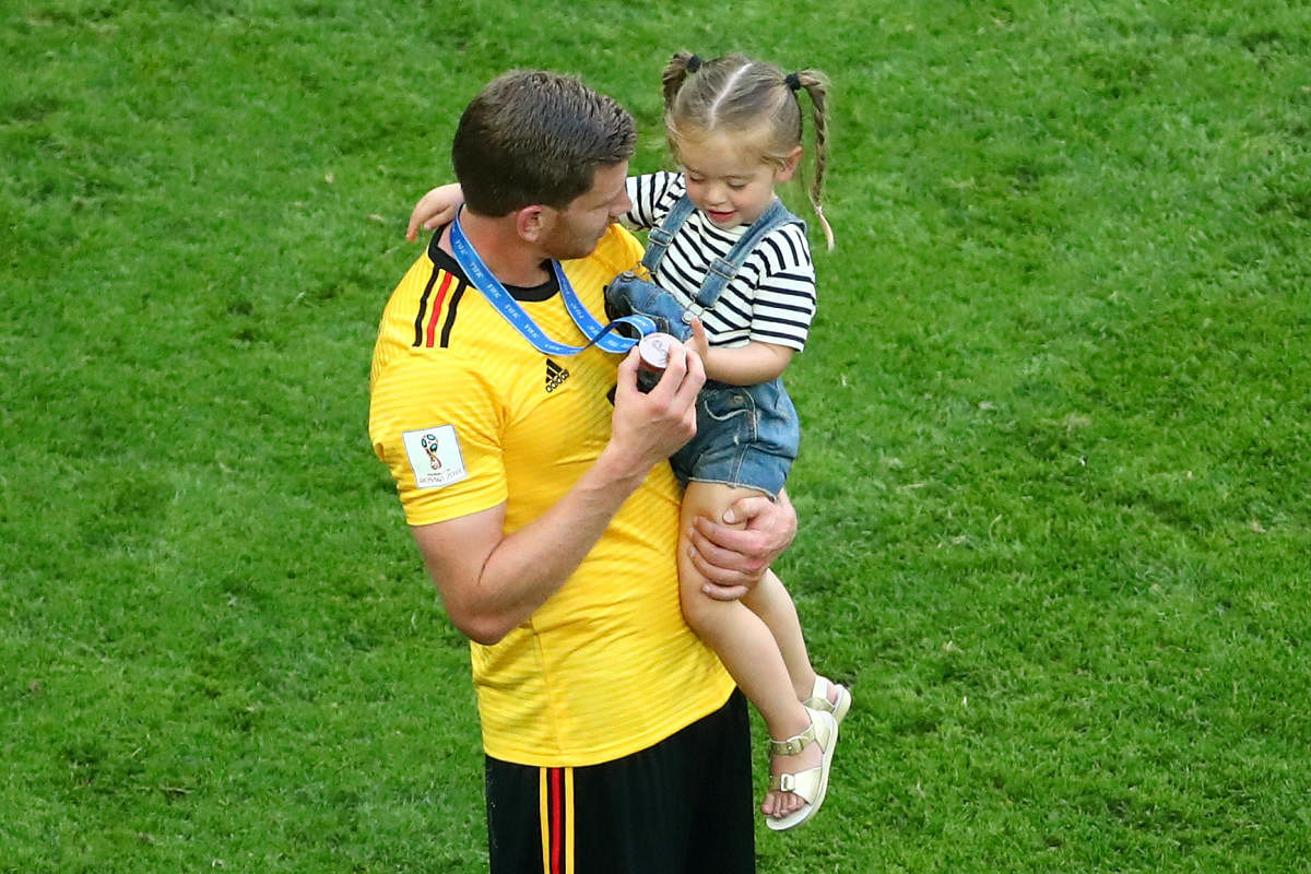 Belgium's Jan Vertonghen shows his medal to his daughter after the match. Reuters Photo