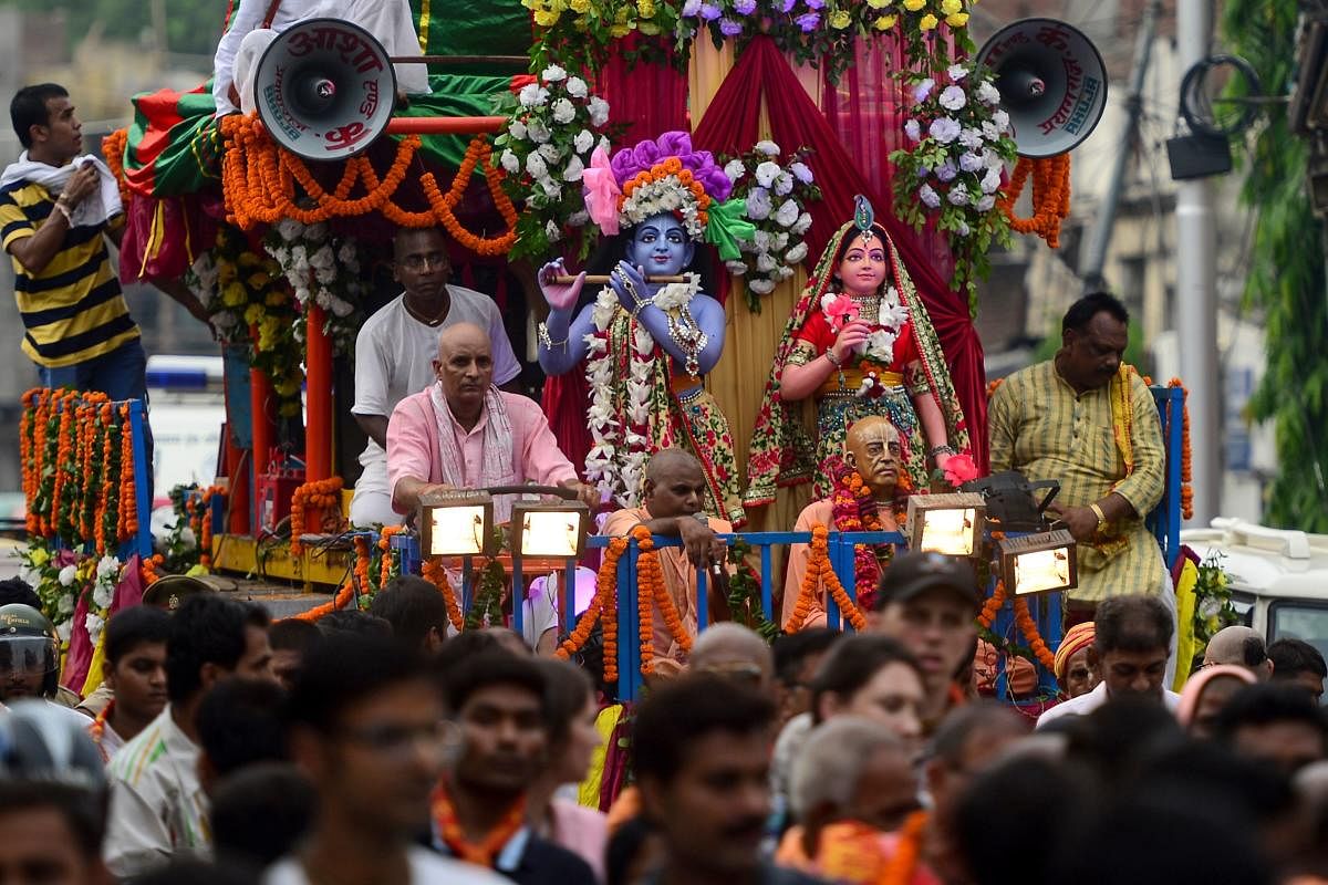 Devotees perform as they participate in a religious procession on the eve of the Janmashtami festival that marks Hindu god Krishna's birthday, in Allahabad on August 23, 2019. (SANJAY KANOJIA / AFP)