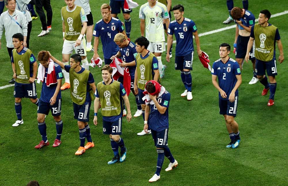 Japan players look dejected after the match REUTERS Photo