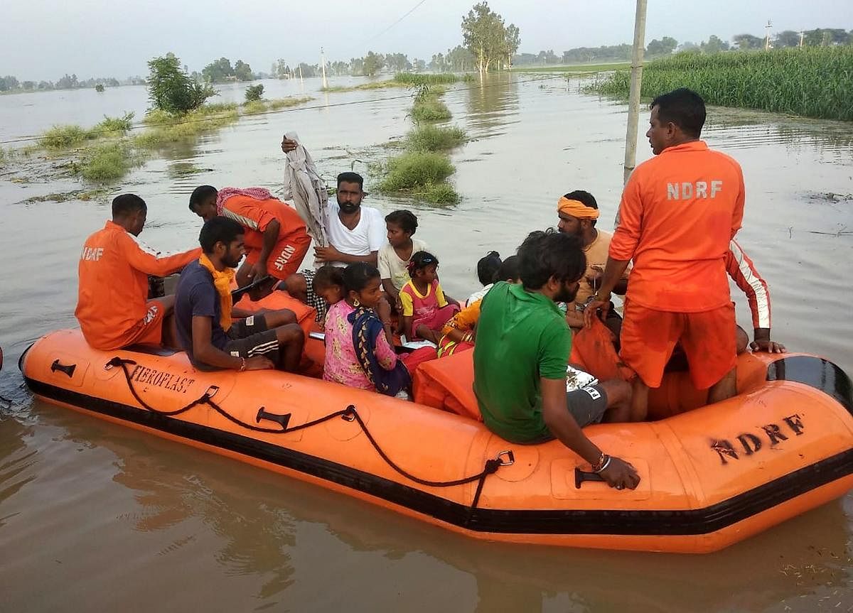 NDRF personnel shift flood affected people from Takia village in Kapurthala district, Sunday, Aug 25, 2019. (PTI Photo)