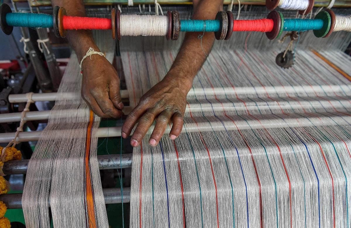 An artisan demonstrates the functioning of mechanised manual loom at a stall at the Khadi Utsav, organised by Khadi and Village Industries Commission on the occasion of 150th Birth Anniversary celebrations of Mahatma Gandhi, in Bengaluru. PTI