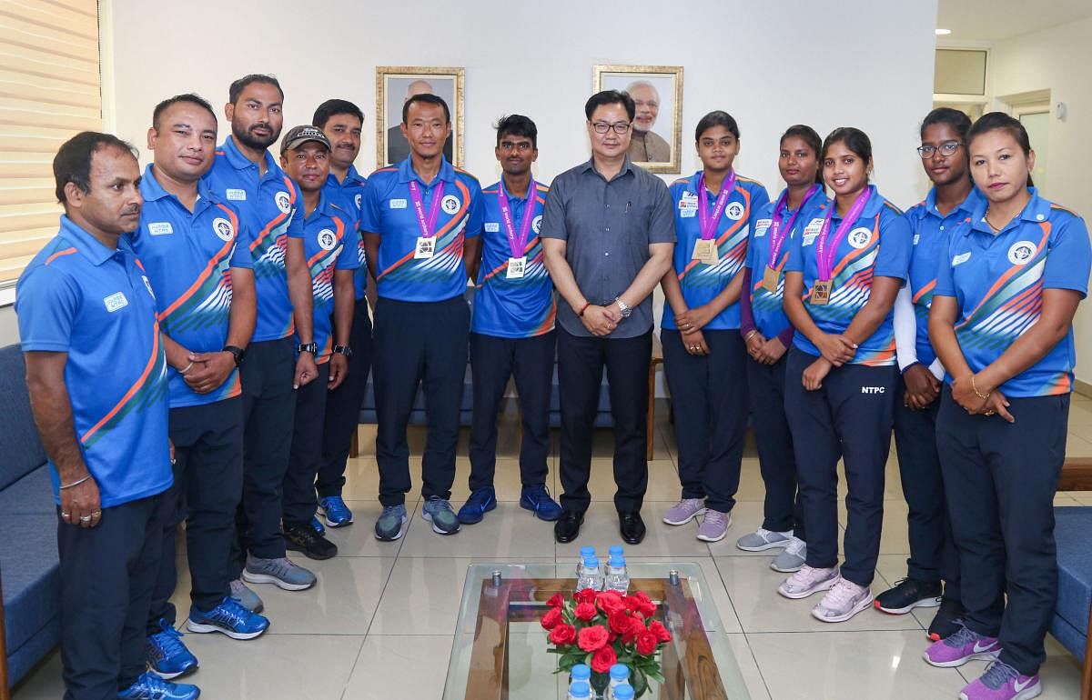 Union Minister of State (Independent) for Youth Affairs & Sports, Kiren Rijiju, pose for a photograph with the Indian archery team at Sports Authority of India, in New Delhi, Wednesday, June 19, 2019. PTI