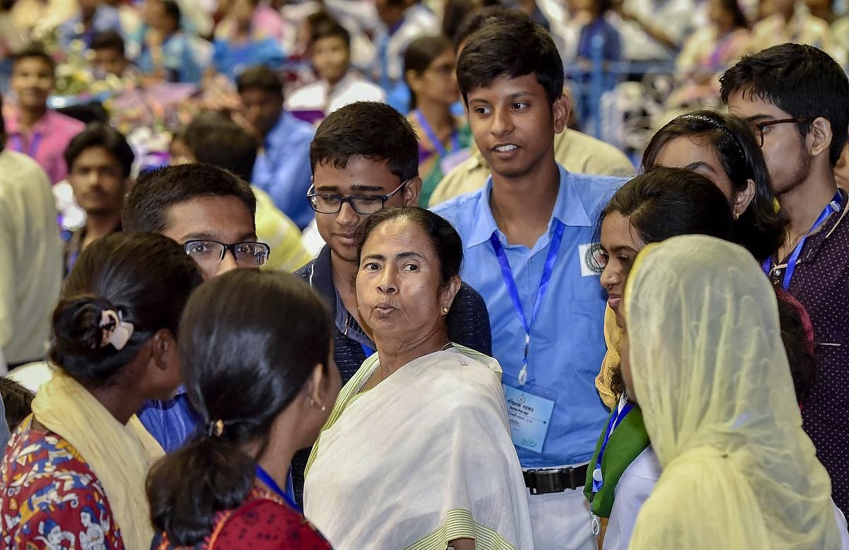 West Bengal Chief Minister Mamata Banerjee interacts with students who topped in Madhyamik Pariksha and Higher Secondary examination during their felicitation program, in Kolkata. PTI Photo