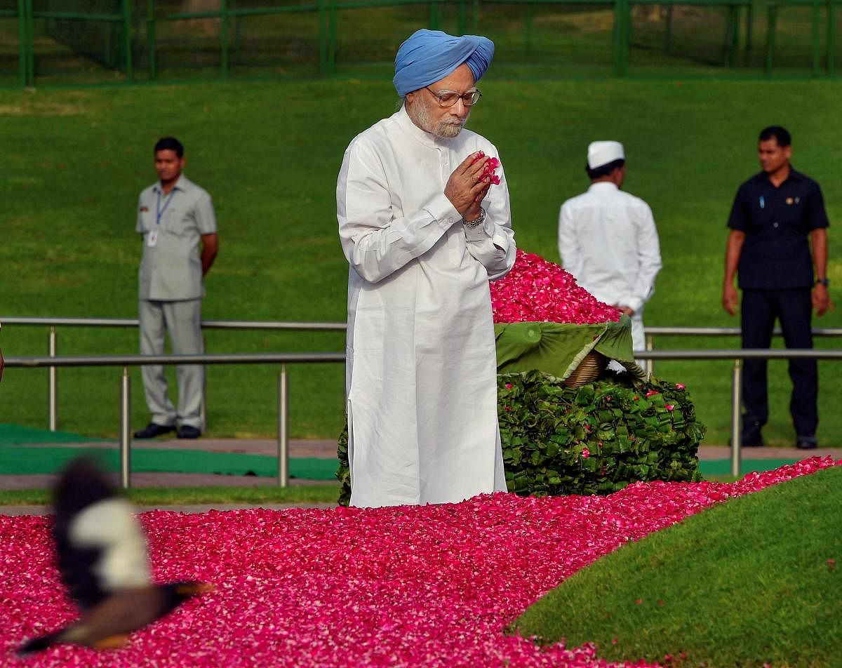 Former prime minister Manmohan Singh pays tribute to India's first prime minister Pandit Jawaharlal Nehru on his 54th death anniversary, at Shanti Van, in New Delhi on Sunday.  PTI Photo