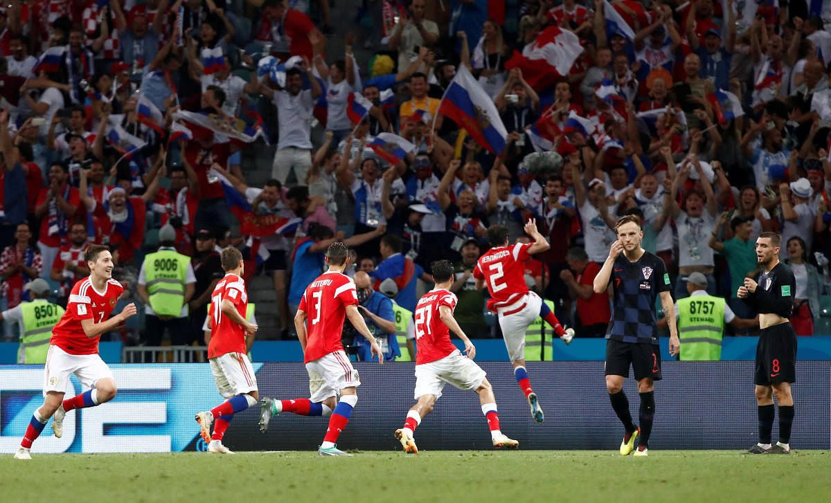 Russia's Mario Fernandes celebrates scoring their second goal with team mates. REUTERS