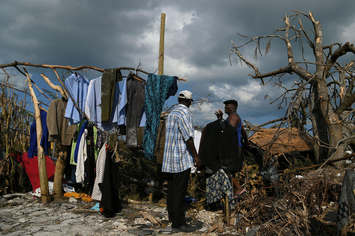 Men work to salvage some of their damaged clothes in a destroyed neighborhood in the wake of Hurricane Dorian in Marsh Harbour. (Photo by Reuters)