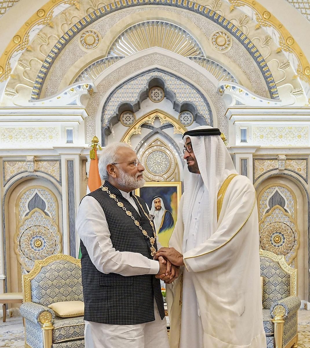Prime Minister Narendra Modi shakes hands with Crown Prince of the Emirate of Abu Dhabi and Deputy Supreme Commander of the United Arab Emirates Armed Forces Sheikh Mohammed bin Zayed Al Nahyan after being conferred ' Order of Zayed'-- UAE's highest civil decoration, in Abu Dhabi, Saturday, Aug 24, 2019. (PTI Photo)